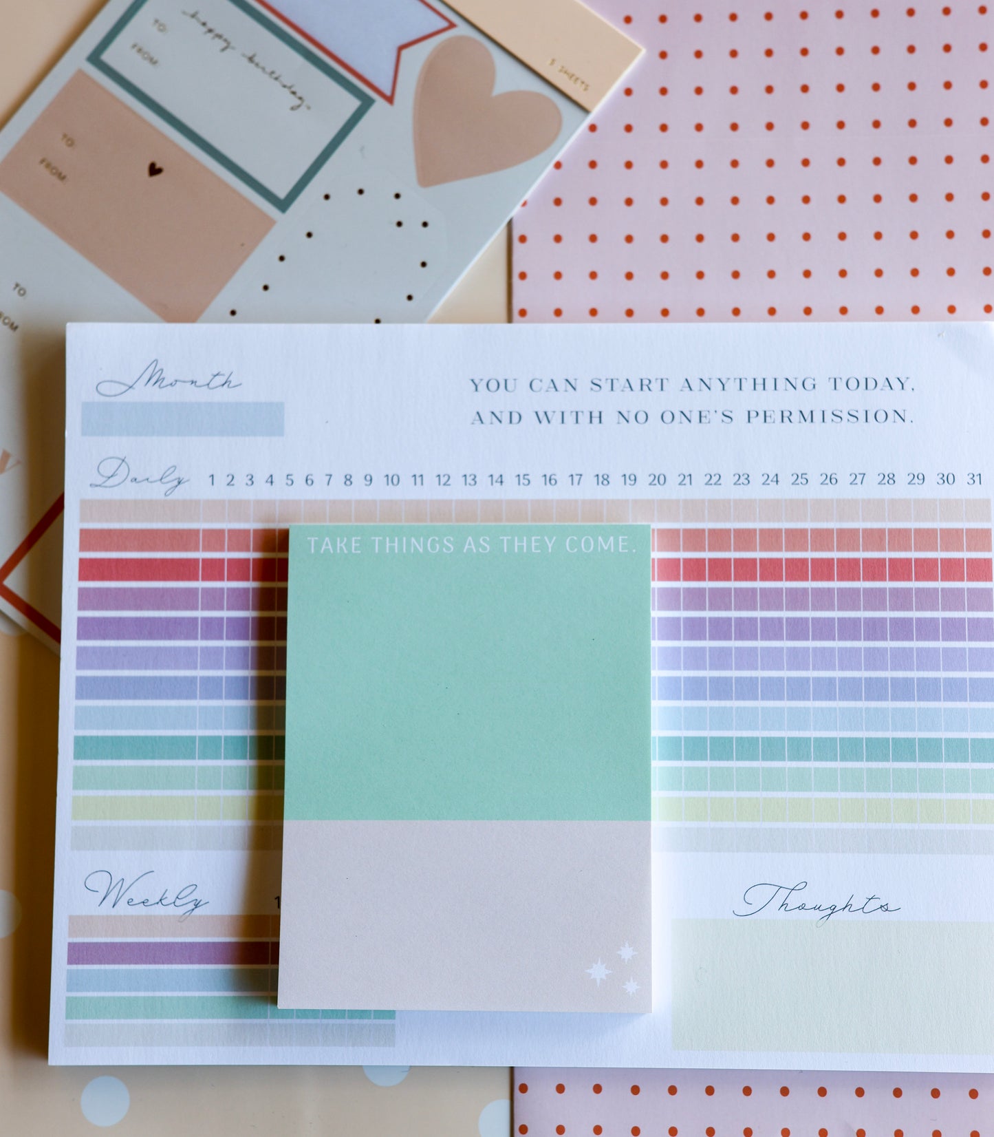 Styled photo of The Gift Set stationery duo — habit tracker and weekly planner tied with ribbon.