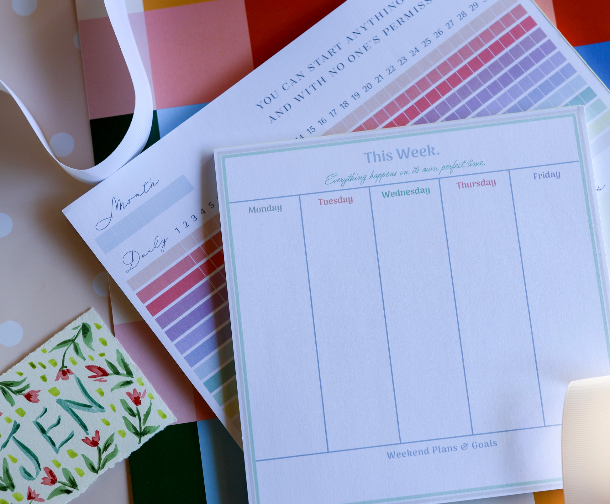 Flat lay of The Gift Set — Magpie x Mamey habit tracker and weekly planner with warm checkered background.