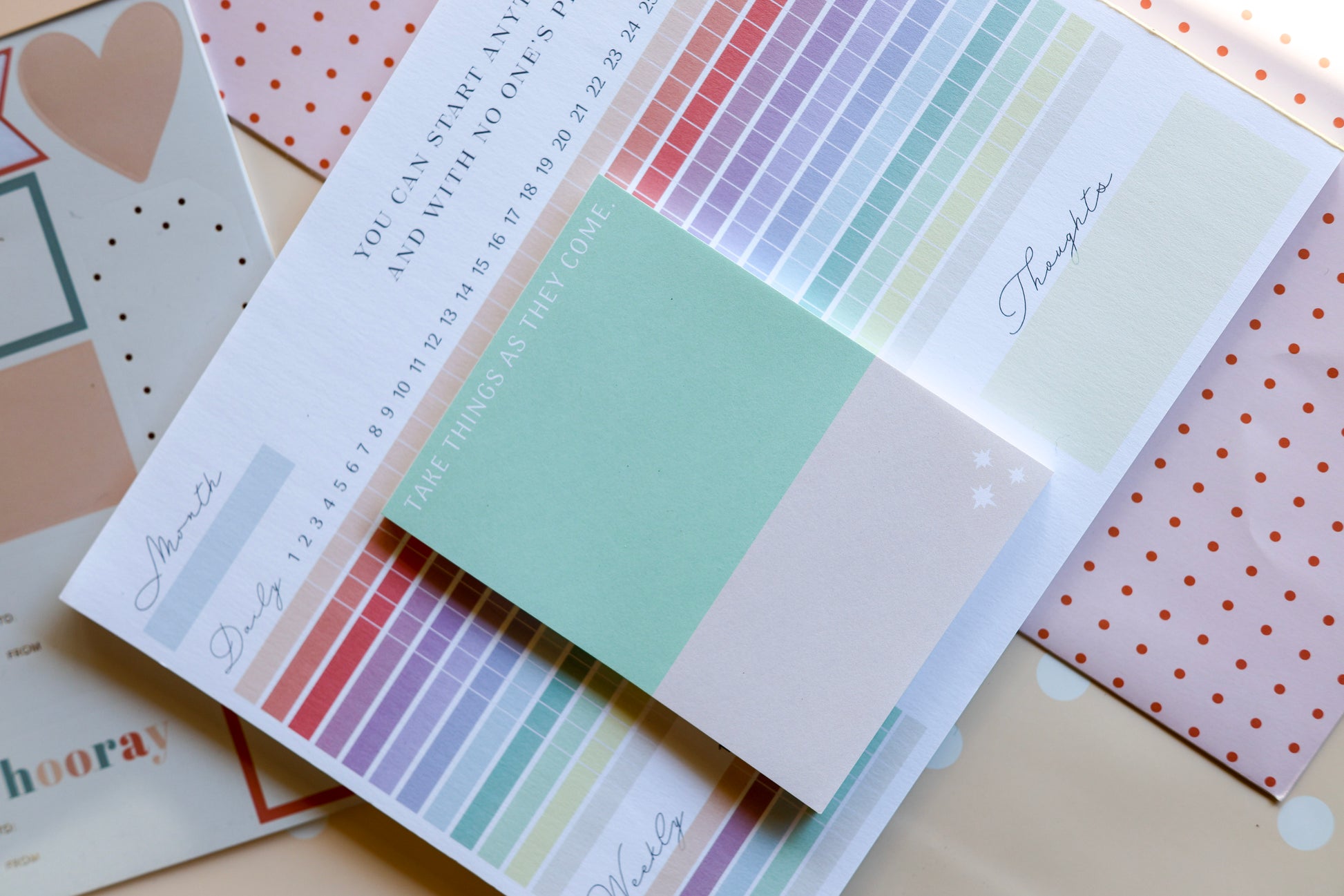 Flat lay of The Gift Set — Magpie x Mamey habit tracker and weekly planner with warm checkered background.