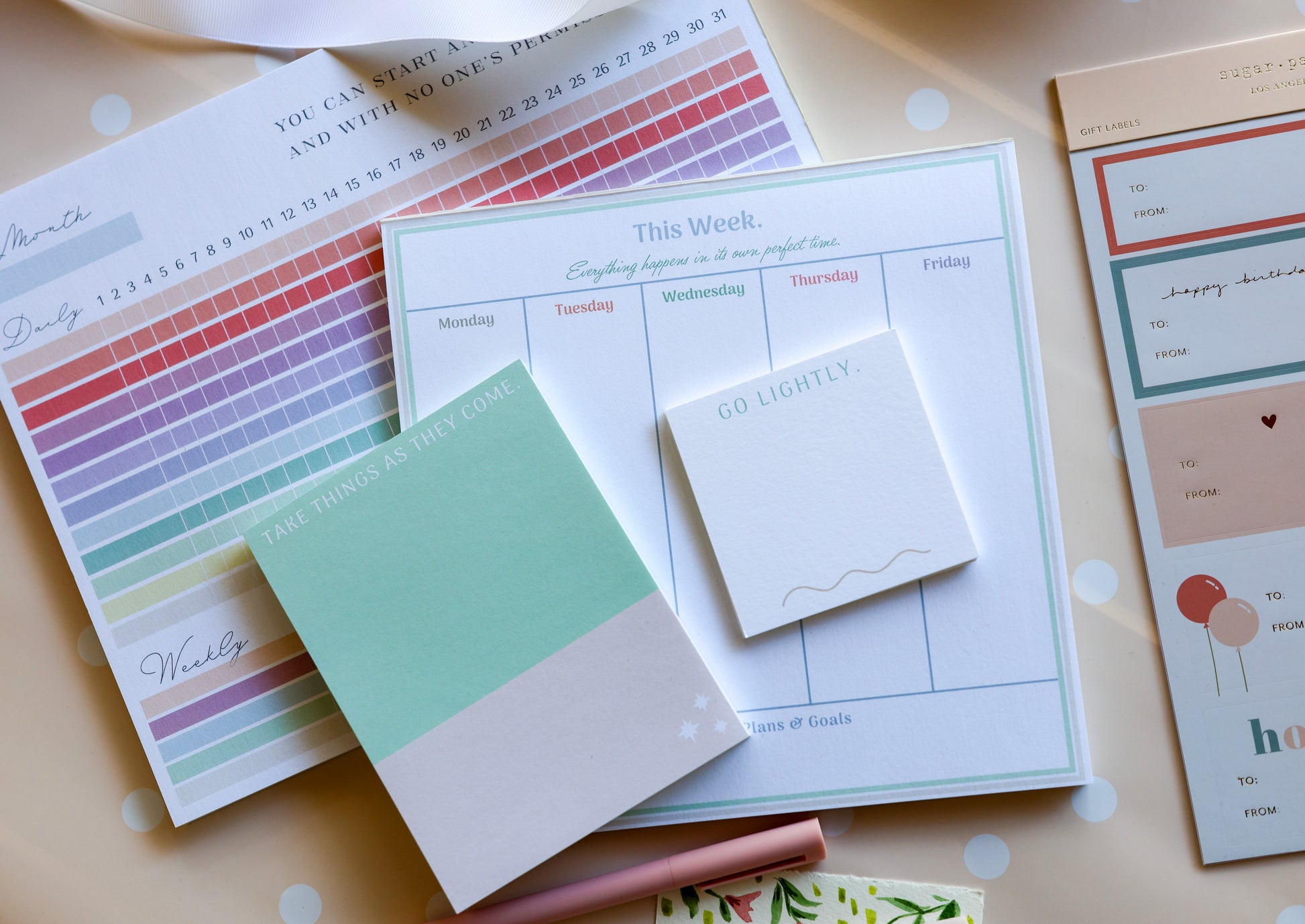 Magpie x Mamey stationery set arranged with pens, scissors, and ribbon on a dotted background.