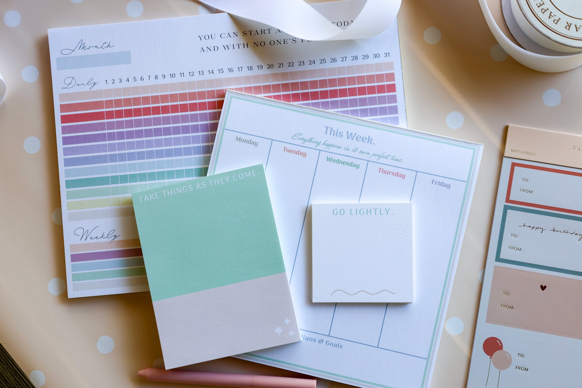 Flat lay of Magpie x Mamey paper suite featuring pastel-hued planner, habit tracker, and notepads.