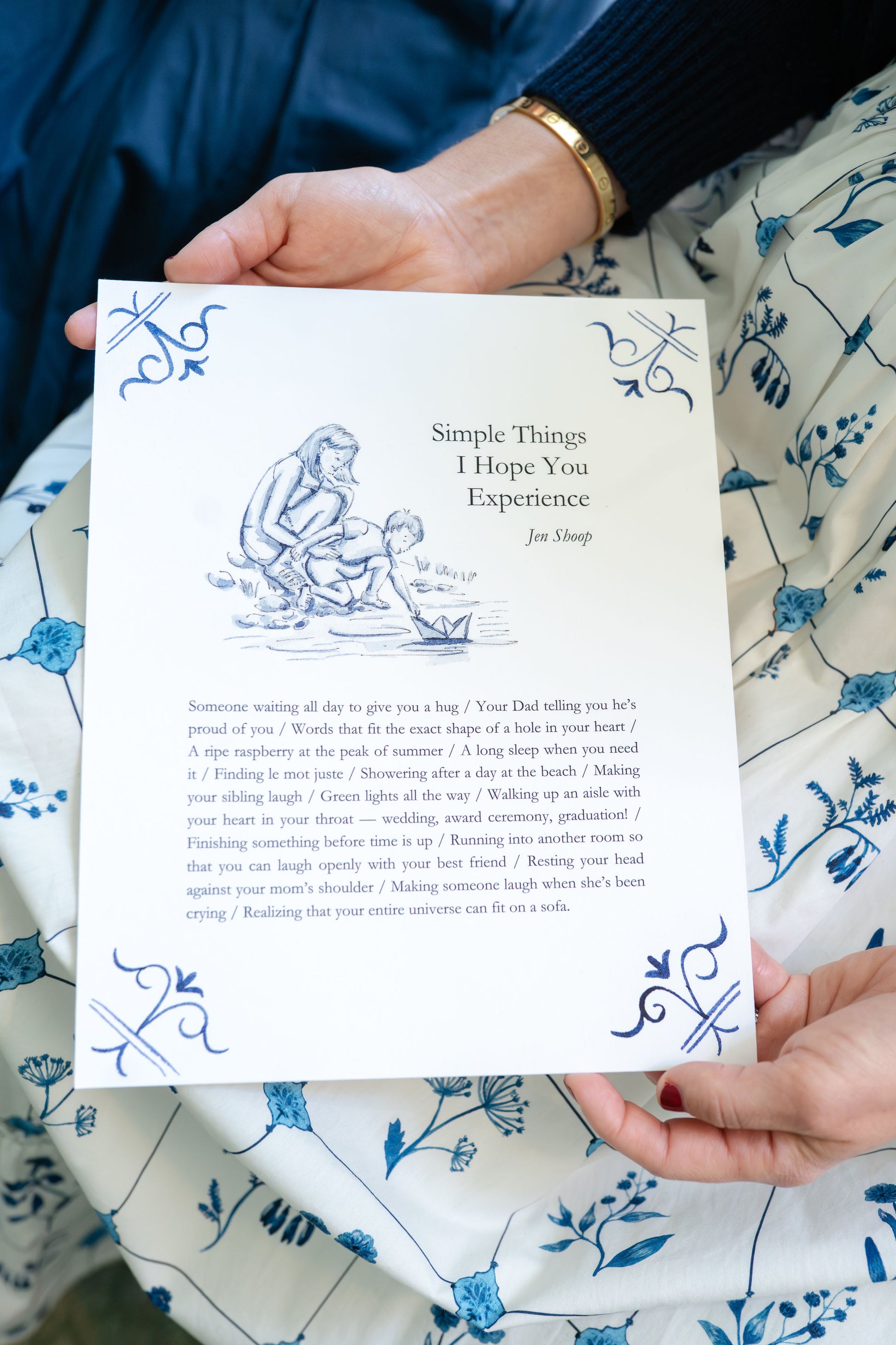 Person holding the Simple Things art print; close view of illustration and prose in blue ink.
